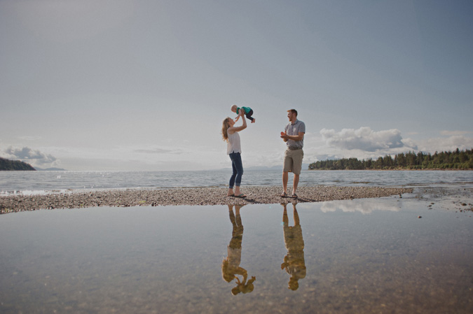 family reflected in a tidal pool, hornby island, bc
