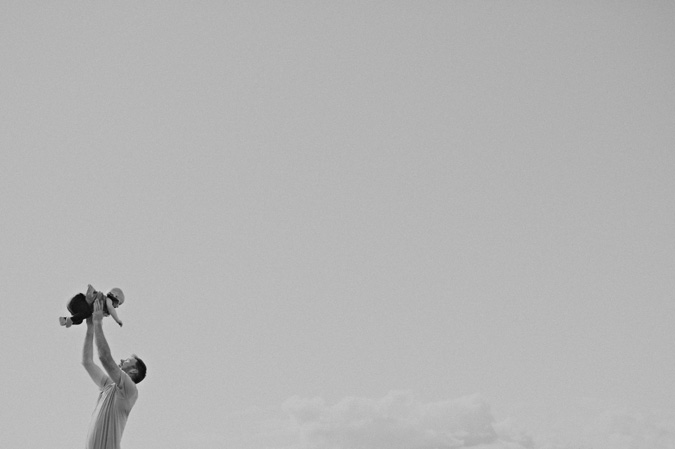 father tossing his baby in the air, hornby island, bc